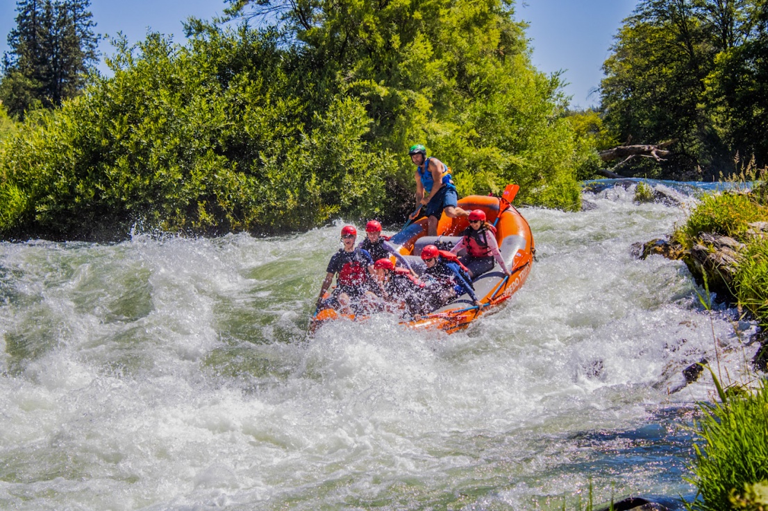 Guide taking a raft in Nugget Falls on the Rogue River 