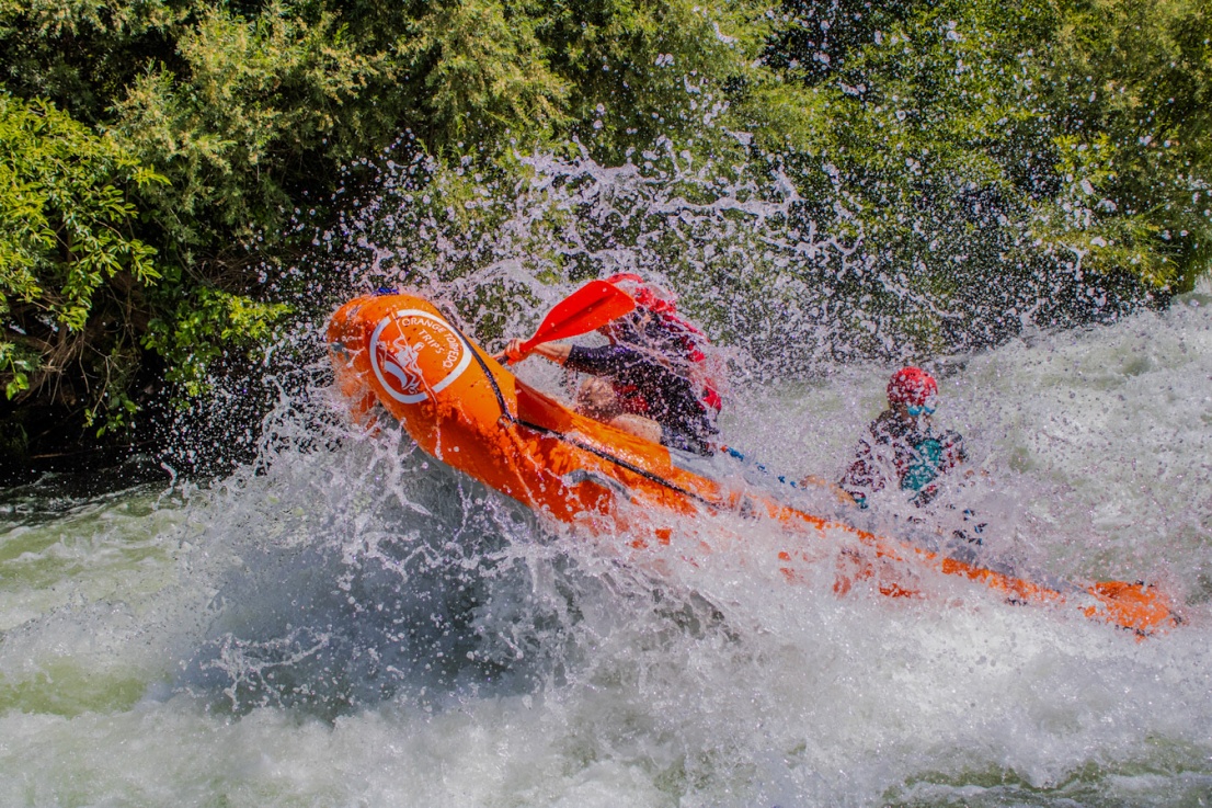 Raft flying into the air in the big wave at Nugget Falls on the Rogue River