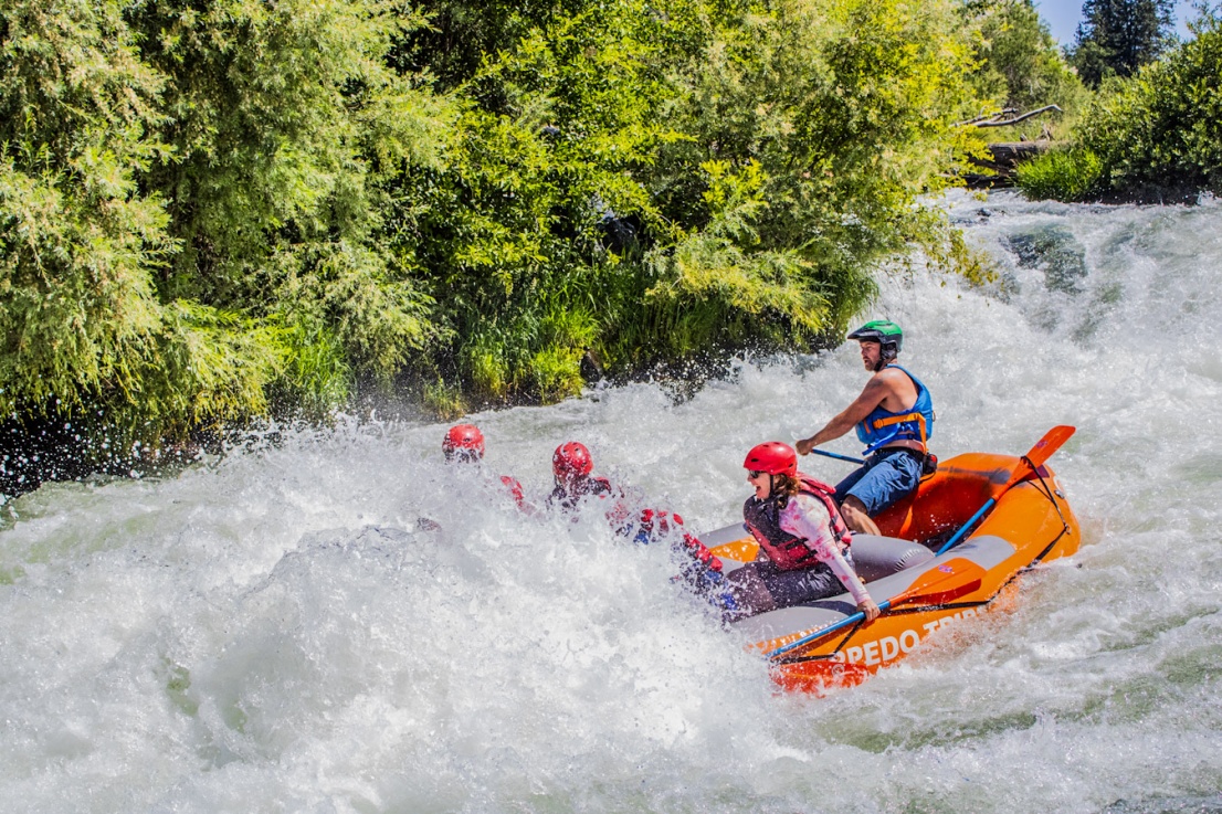 Raft disappearing into the biggest wave in Nugget Falls on the Rogue River