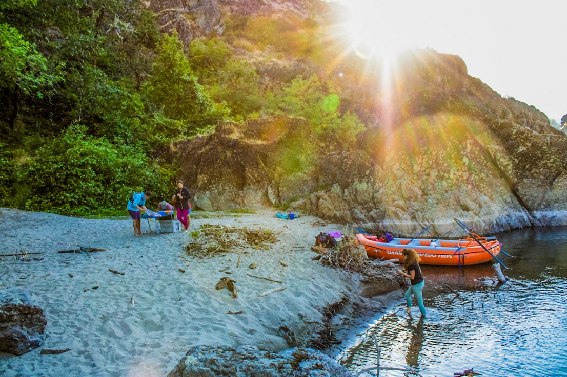 Group of rafters on the beach near the Rogue River at sunset