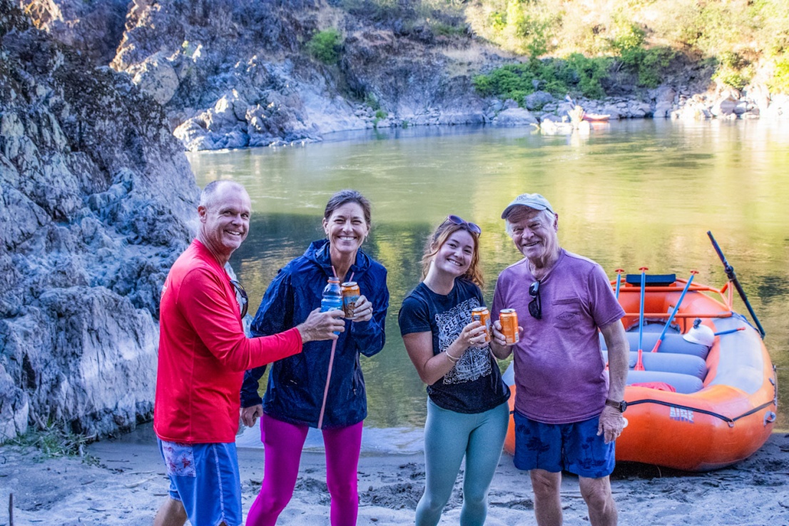 Family taking a photo on the beach next to the Rogue River