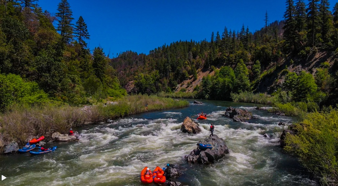 Group in raft going through Dragons Tooth rapid on the Klamath River