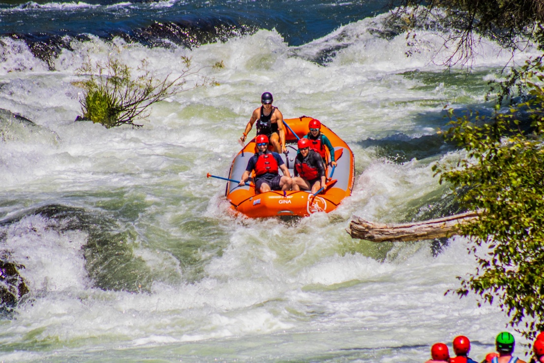 Family in a raft going over Tilomikh falls on the Rogue River