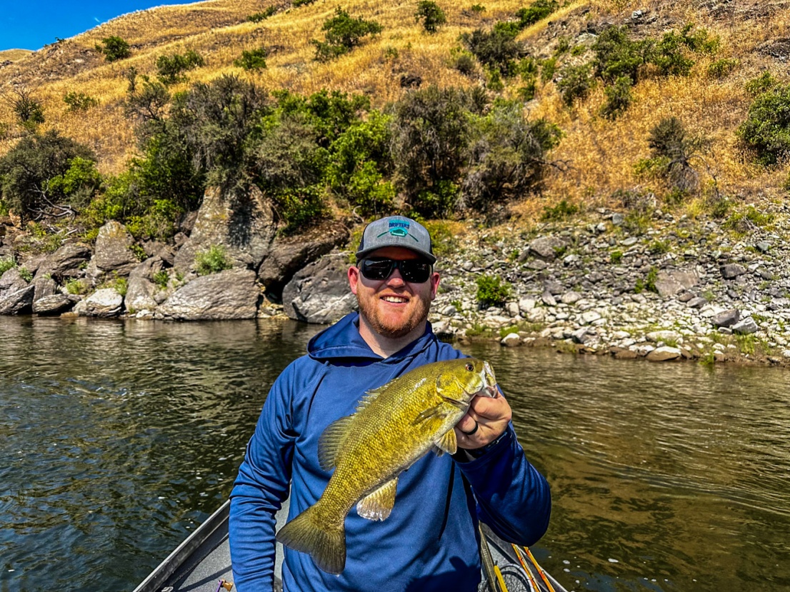 Guide holding a bass on the salmon